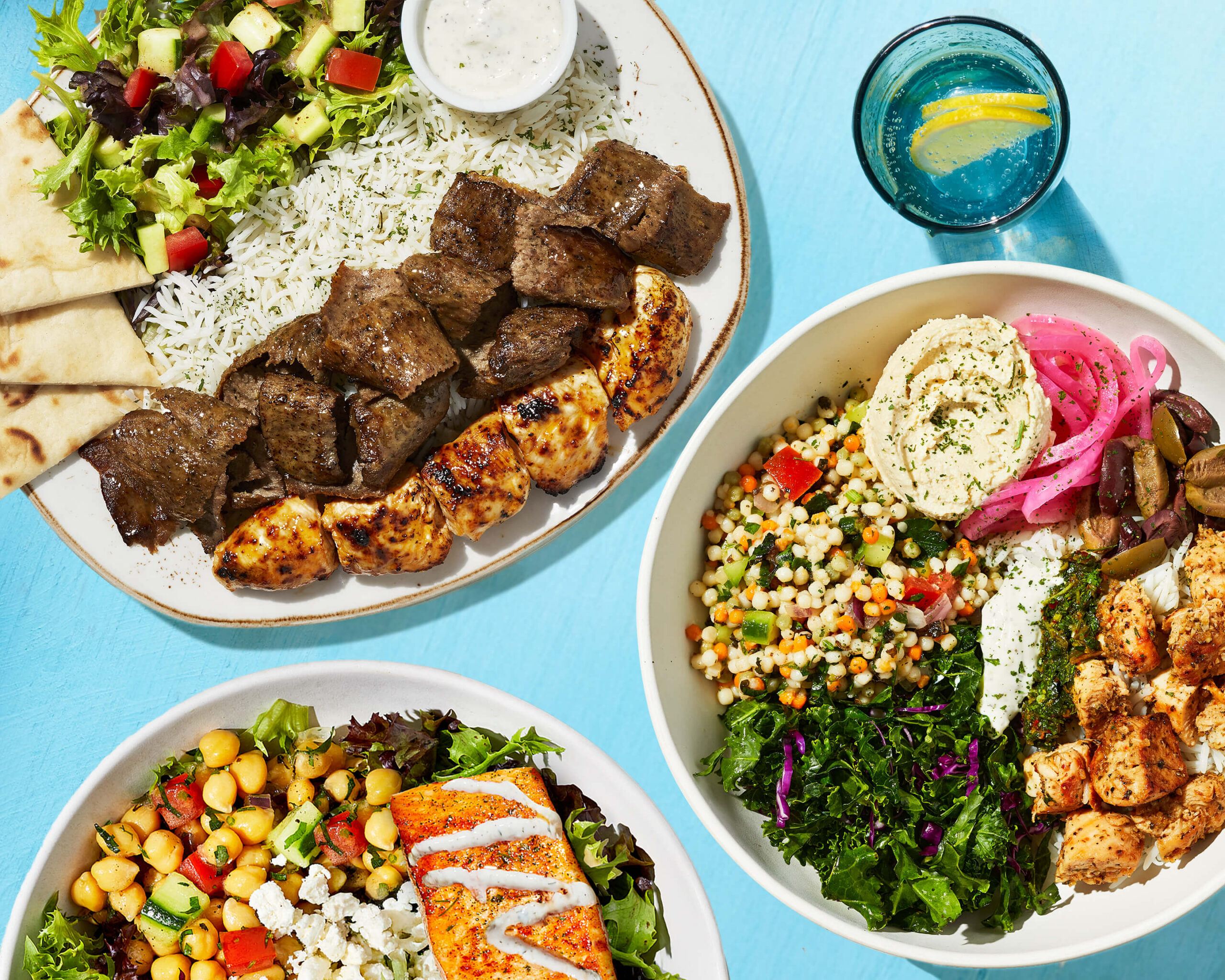 A photo of Luna Grill's Chicken and Gyro Plate, Santorini Bowl, and Salmon Bowl